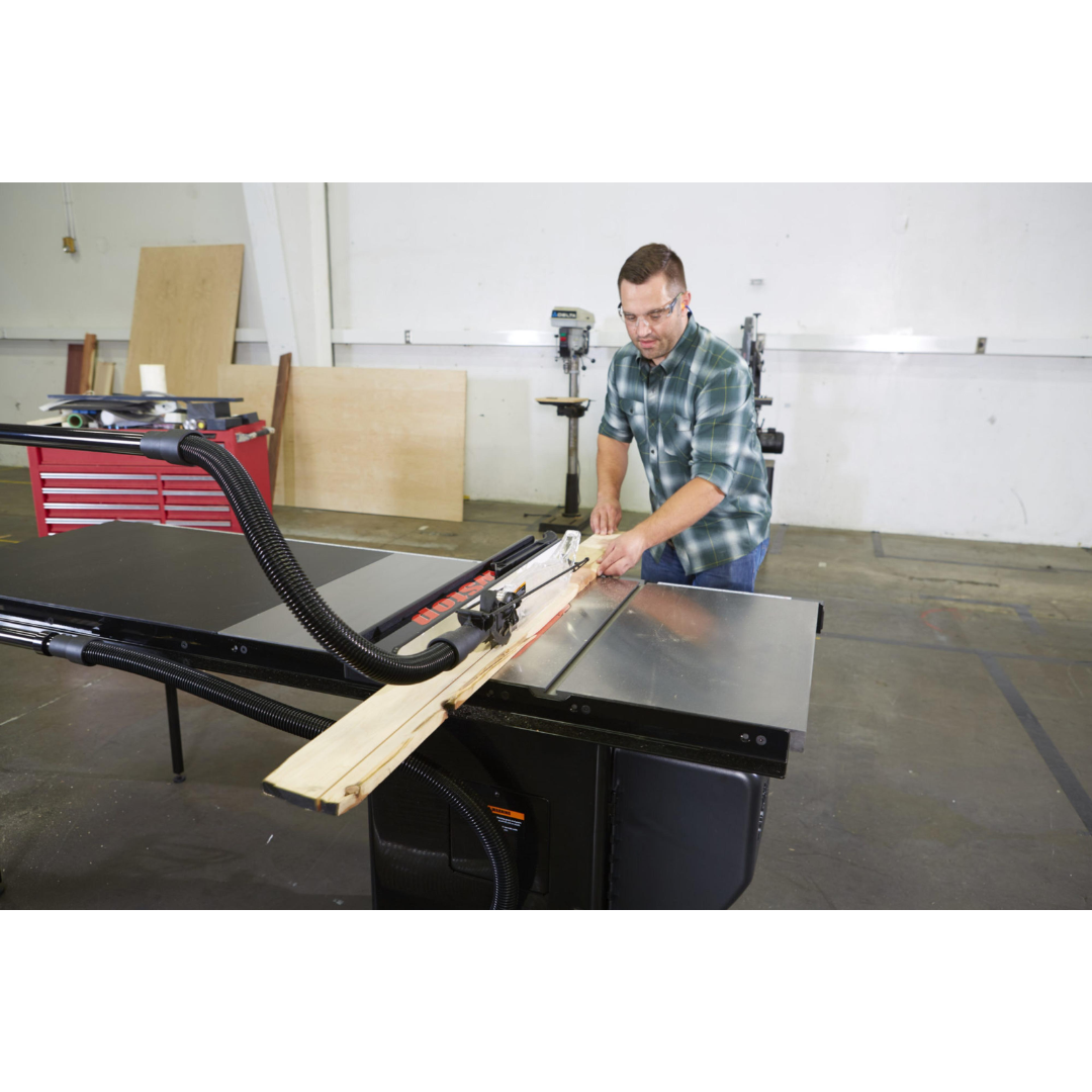 SawStop Overarm Dust Collection TSA-ODC in use during a ripping operation, capturing airborne dust directly at the source above the blade.