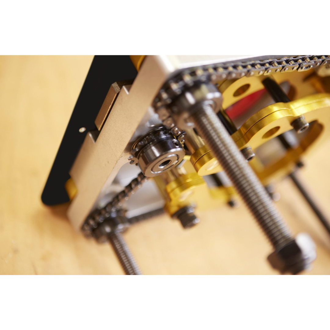 SawStop Router Lift RT-LFT router lift components displayed on a workbench, featuring precision-machined hardware and installation accessories for professional woodworking applications.