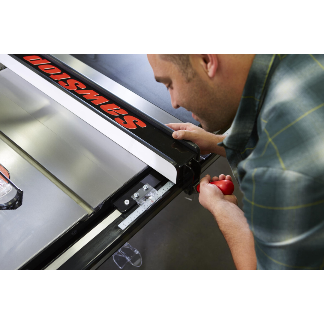 SawStop T-Glide Advance Fence installed on a table saw while being adjusted by an operator, demonstrating smooth fence movement and precise setup capabilities.