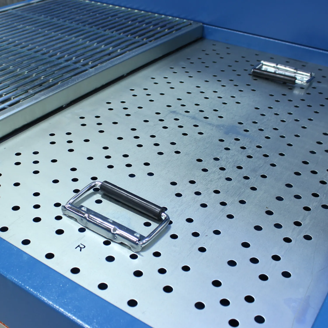 Top perforated work surface of the Baileigh 48" x 40" Heavy-Duty Downdraft Table, 2 HP (DDTM-4840-HD) 1017589 designed for efficient airflow, particulate capture, and welding dust collection.
