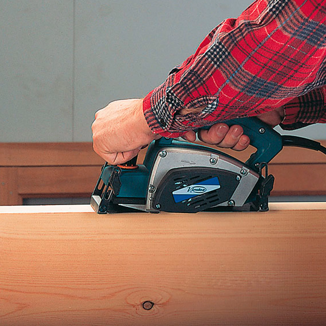 Virutex CE96H Compass Planer For Curved Surfaces (120V) 9600099 in use on a wooden surface demonstrating smooth curved planing operation.