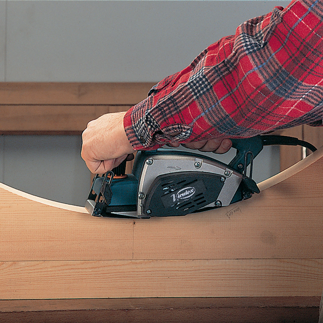 Virutex CE96H Compass Planer For Curved Surfaces (120V) 9600099 in use on a wooden surface demonstrating smooth curved planing operation