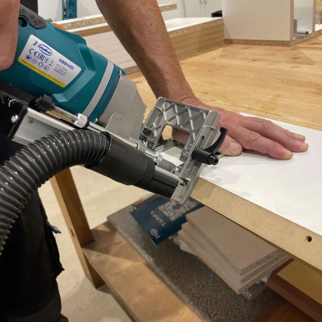 Virutex Cordless Dowel Jointer TWOO ABB400 (With 2 Batteries & Charger) 7900801 performing edge dowel drilling on solid wood panel with precision guide fence
