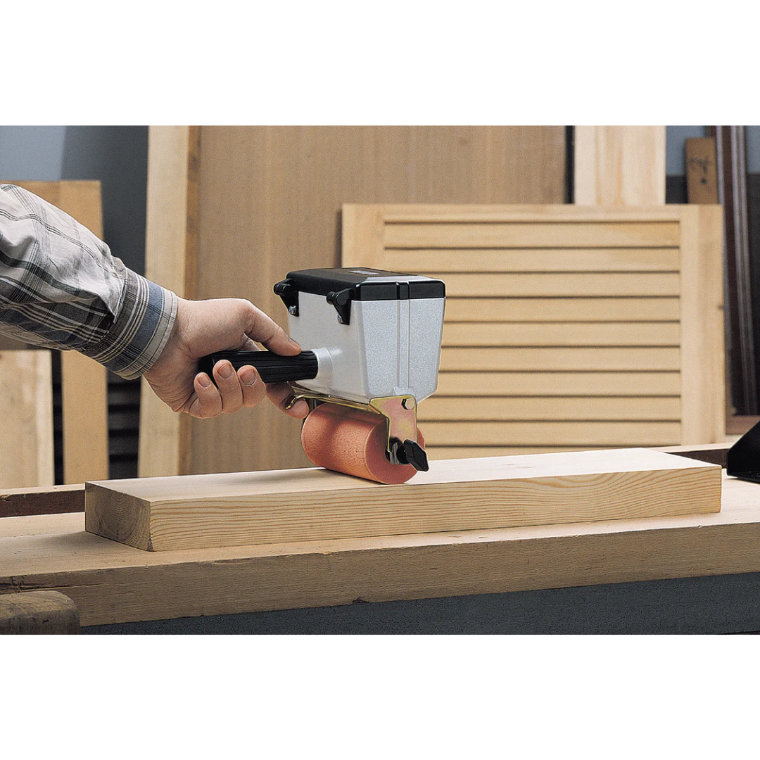 Virutex EM125T Handheld Gluer With Upper Roller 2500300 in use applying adhesive to panel edge demonstrating precision glue distribution and controlled handling.