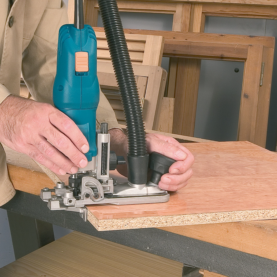Virutex FR292R Electronic Tiltable Trimmer (120V) 9200499 performing precision trimming on wood surface with controlled handling