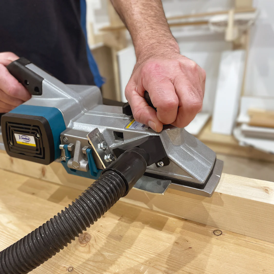 Virutex Hand Planer CE24E For Fine Finishing (120V) 2400199 being used on a wooden surface demonstrating controlled fine finishing and accurate material removal.