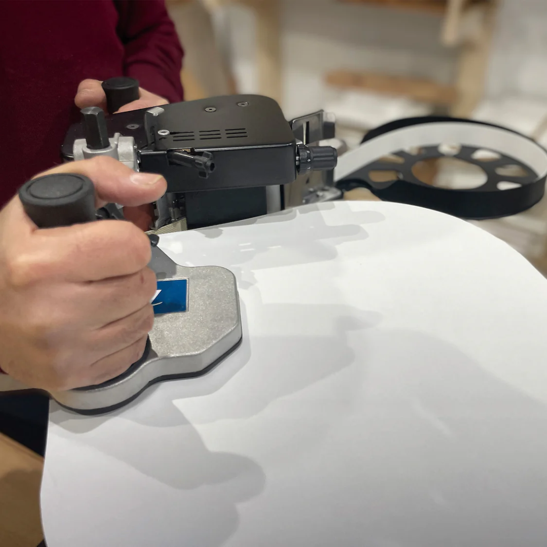 Virutex Hot Melt Portable Edgebander PEB250 Evolution (120V) 5000895 demonstrating glue application and trimming operation on work surface
