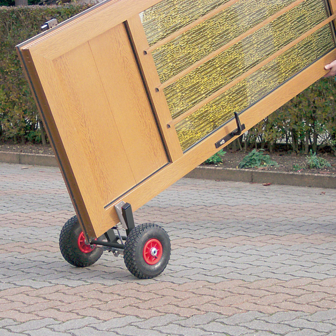 Virutex SPR770T Clamping Dolly For Door Panels: Easy Mobility 7000700 in use moving a wooden door panel across a paved surface