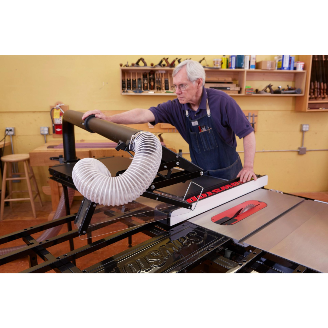 Woodworker operating a table saw equipped with the SawStop Floating Overarm Dust Collection TSG-FDC for cleaner and safer woodworking performance.