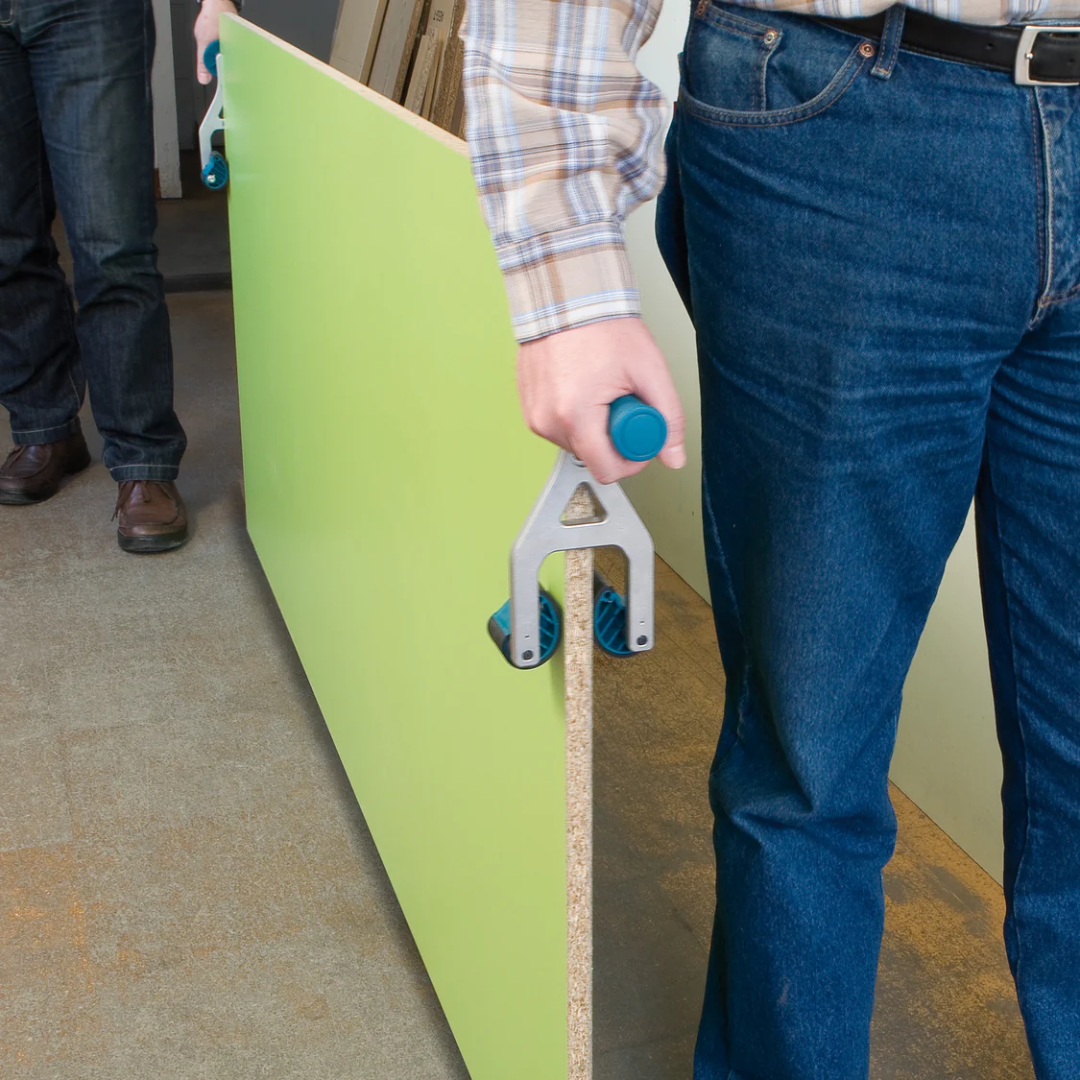 Worker carrying a large panel with Virutex Transport Handle PT81U: Easy Portability 8100100 showing ergonomic grip and improved portability