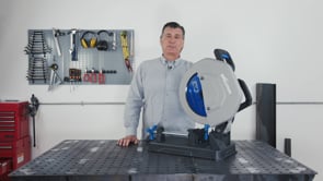 Evolution Power Tools Metal Cutting Chop Saw With 14 in. Mild Steel Blade S355CPSL displayed on a workbench with an operator, highlighting its compact design and portable construction for professional metal fabrication.