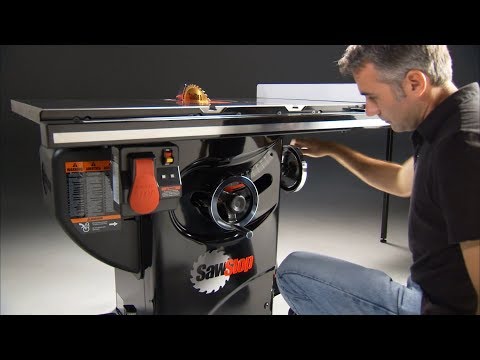 Woodworker operating the SawStop Professional Cabinet Saw, demonstrating professional-grade cutting performance and advanced safety features.