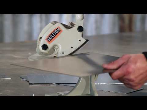 Close-up action view of the Baileigh Throatless Shear - (MPS-1) 1005677 demonstrating controlled cutting of sheet metal for curved and intricate shapes.