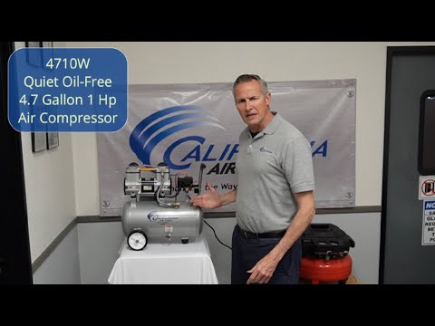California Air Tools 4710W 4.7 Gal 1.0 Hp Quiet Air Compressor shown in a workshop setting with compact wheeled portable design