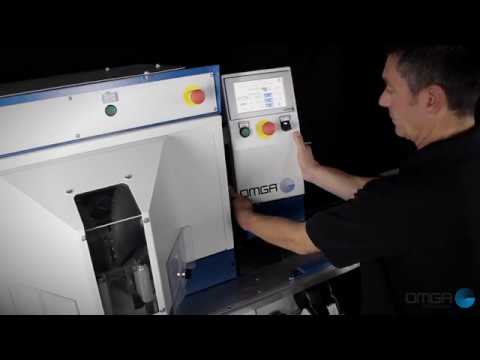 Operator using the OMGA V 235 Double Mitre Saw touchscreen control interface for accurate programmable miter cutting operations